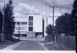 Samfundsbygningen med splintsikringsvegg foran inngangen under krigen.