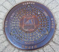 Kumlokk med Flekkefjords kommunevåpen. Foto: Elin Olsen