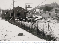 Flybataljonens hangar utbombet, tatt fra Fetveien. Brukt av BMW under krigen. Kamuflasjen som landbruksbygg godt synlig på taket.