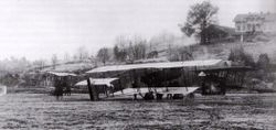 Bildet viser fly av typen Henri Farman F40 med Kjeller gård i bakgrunnen. Foto FLO Kjeller arkiv.
