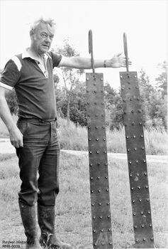 Thor Kolsrud på Øvre Høvik gård med piggede jernplater. Disse ble plassert i bratte isrenner for å bremse farten på isblokkene som ble sendt ned isrenna. Brukt fra 1880-1950 (Foto Ole Sønju - Røyken Historielag) .