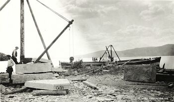 Dagbrudd for Røykengranitt ble etablert langs Drammensfjorden fra 1875. Nærhet til fjorden var viktig, da sjøtransport med jakter og på lektere var det beste alternativet for transport av produktet til markedene i de store byene. I Hyggen-området var det flere lasteplasser for Røykengranitt. På bildet fra et av bruddene i Hyggen, blir store granittblokker lastet over på lektere.(Fotograf ukjent)