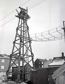 En av de 50 bærebukkene på taubanen med et av beskyttelsesnettene hvor banene passerte vei/jernbane eller bebyggelse. Foto: Martin Knoph/Steinkjerleksikonet (rundt 1950).
